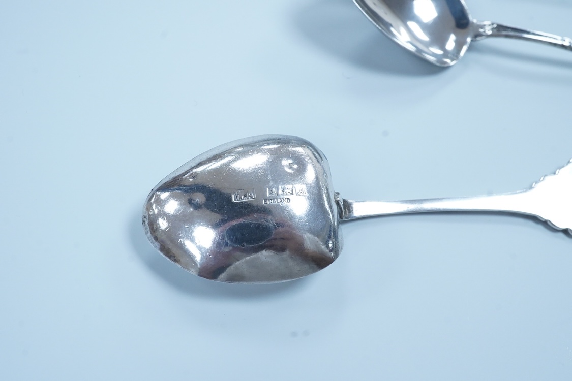 A pair of George VI silver sauceboats, with scroll handles, Stokes & Ireland, 1936, 16.2cm, together with four silver tennis related teaspoons (1 a.f.) and two small silver condiment spoons.